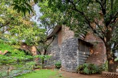 an old brick building is surrounded by trees