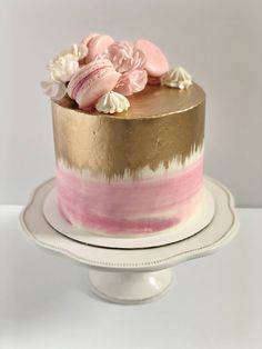 Pink cake with gold painted on top and down the sides, topped with macarons, meringues and flowers. Pink Cake With Macarons, Birthday Cake With Macarons On Top, Cakes With Macarons On Top, Gold Ombre Cake, Cake With Macarons On Top, Cake With Gold, 11 Birthday