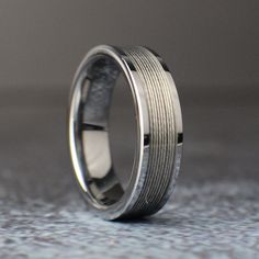 a wedding band with two rows of silver inlayed to the inside of it