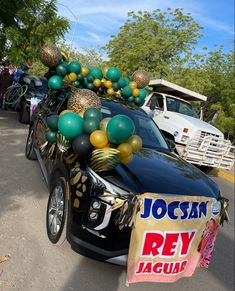 a car with balloons and streamers on the hood