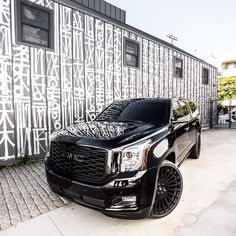 a black truck parked in front of a building