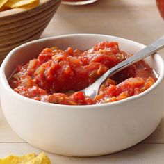 a white bowl filled with salsa and chips