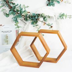 two wooden hexagonal frames sitting next to each other