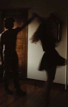 a blurry image of two people dancing in the dark