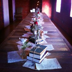 the long table is covered with books and flowers