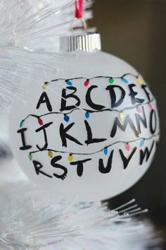 a white ornament with letters and numbers on it