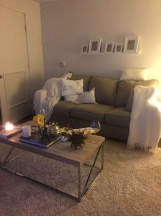 a living room filled with furniture and candles