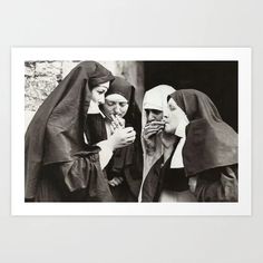 an old photo of three women dressed in nun costumes eating something out of their hands