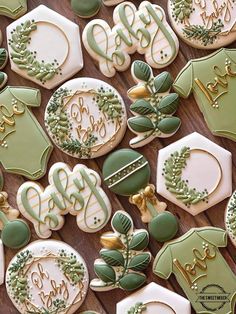 decorated cookies with green and white frosting on a table