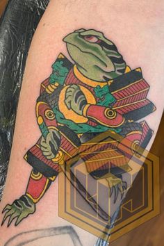 a tattoo on the leg of a person with a lizard and other items in it