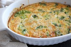 a casserole dish with broccoli and cheese in it on a table