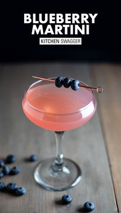 the blueberry martini is garnished with fresh blueberries