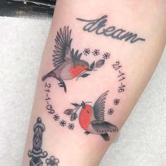 a tattoo with two birds and the words dream on it