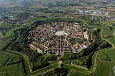 an aerial view of a city surrounded by green fields