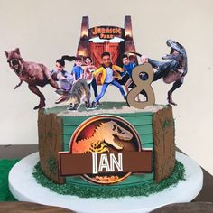 a birthday cake with an image of dinosaurs on it