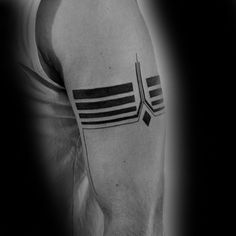 a black and white photo of a man's arm with a tattoo on it