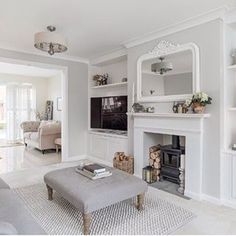 a living room filled with furniture and a fire place