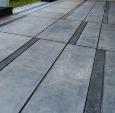 an empty patio with steps leading up to the door and grass in the back ground