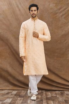 Pastel coral kurta with floral embroidery and mandarin collar. Paired with churidar.
Component: 2
Pattern: Embroidered
Type Of Work: Floral
Neckline: Mandarin
Sleeve Type: Full Sleeves
Fabric: Cotton
Color: Coral
Other Details: 
Front buttons
Mandarin neck
Occasion: Puja - Aza Fashions Kurta Set For Men, Color Coral, Churidar, Kurta Set, Full Sleeves, Mandarin Collar, Aza Fashion, Full Sleeve, Fabric Cotton