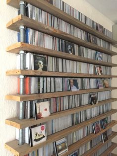 the shelves are filled with various cd's and cds, all in different sizes