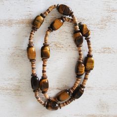 The warm earthy tones of tiger's eye are showcased in this necklace from Jaques in Brazil. The artisan intersperses the gemstone beads with discs of natural coconut shell for an appealing combination. Diy Jewelry Set, Earth Goddess, Jewerly Making, Tigers Eye Necklace, Beads Bracelet Design, Detailed Jewelry, Tiger Eye Beads, Coconut Shell, Tiger's Eye