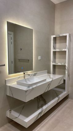 a bathroom with a sink, mirror and shelving unit in the middle of it