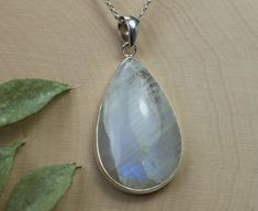 This is a beautiful Rainbow Moonstone from India set in Sterling Silver. This amazing stone has a unique look to them that you will not see with any other stone! It has a milky color that has flashes of blues, purples and some yellows when the light hits them in the right places, just like a Rainbow! This stone has a nice luster due to the cabochon roundness.  This larger 32mm X 21mm Pear Rainbow Moonstone weigh 22.65cts and will go great with most styles or occasions. Check out our Cabochon Stud Earring section for our matching 6mm Rainbow Moonstone Stud Earrings! A Cabochon gemstone is rounded and polished instead of having many facets. If you have any questions, please feel free to ask! Handmade White Moonstone Gemstones, White Moonstone Gemstones With Spiritual Style, Spiritual White Moonstone Gemstones, White Moonstone Gemstones As Gift, White Moonstone Gemstones For Gift, Rainbow Moonstone Pendant, Moonstone Pendant, Beautiful Rainbow, Rolo Chain