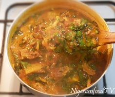 a pot filled with soup sitting on top of a stove