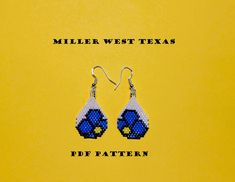 a pair of blue and white beaded earrings with the words miller west texas on it