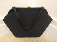 "This is a wonderful, elegant, Black Fabric Handbag/Purse that was made in the late 1950s, early 1960s. It is lined in BLACK silky fabric with a layered slot pocket. No maker's mark or tag. The bag has a great trapezoid shape!  It is so much prettier in person. This is a LARGE purse, please check the measurements to assure that this bag will work for you. MEASUREMENTS: Total Height with handle: 18.0\" Length: 11.0\" (measured on bottom) Width: 4.0 \" Depth: 11.0 \" The purse has gold tone hardwa Retro Black Bags For Vintage Events, Retro Black Evening Bag For Formal Occasions, 70s Mini Dress, Turquoise Purse, Fabric Handbags, Cool Store, Polyester Dress, Pocket Book, Lovely Dresses