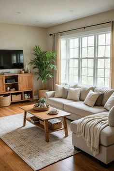 a living room filled with furniture and a flat screen tv on top of a wooden table