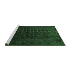 a green area rug with white border on the top and bottom, in front of a white background