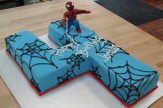 a spiderman birthday cake on top of a table