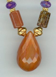 Elegant Faceted Carnelian Necklace, Gold Teardrop Agate Necklace, Unique Briolette Natural Stones Necklace, Unique Briolette Necklace With Natural Stones, Amber Teardrop Necklaces For Jewelry Making, Amber Teardrop Necklace For Jewelry Making, Handmade Amber Teardrop Pendant Necklace, Elegant Brown Carnelian Necklace, Orange Gemstone Beads And Cabochons As Gifts