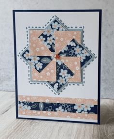 a close up of a card with flowers on it and a blue border around the edges