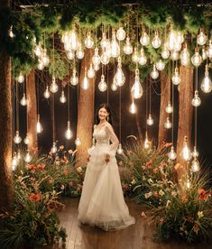 a bride and groom standing in front of an arrangement of lights