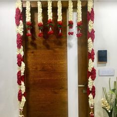 the door is decorated with red and white flowers, hanging from it's side