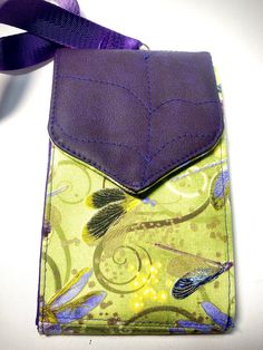 a small purse with a purple ribbon attached to it