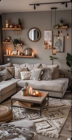 a living room filled with lots of furniture and candles on top of the coffee table