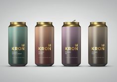 three cans of kron are shown in this image, one has gold and the other is green