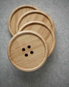 four wooden buttons are shown on the surface