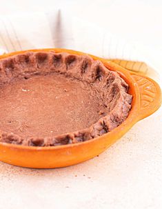 a chocolate pie sitting on top of a white table