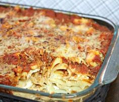 a casserole dish with meat and cheese in a glass pan on a table