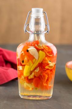 a glass bottle filled with fruit and veggies