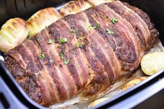 a roasting pan filled with meat and potatoes