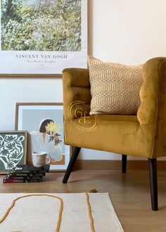 a yellow chair sitting on top of a hard wood floor next to a white rug