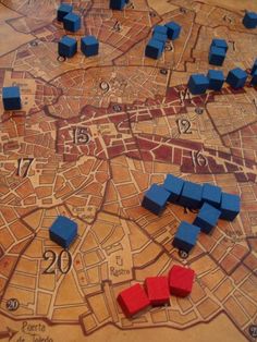 a board game with blue cubes and red ones on the map, all marked out