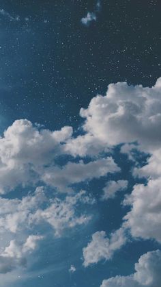 the sky is filled with clouds and stars