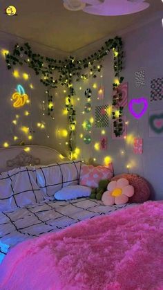 a bedroom with lights on the wall and pink bedding