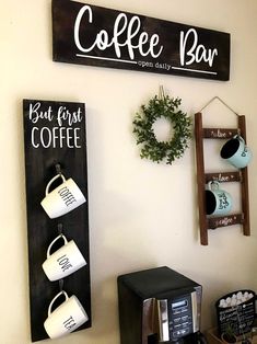 coffee bar sign hanging on the wall next to a cup holder with two mugs